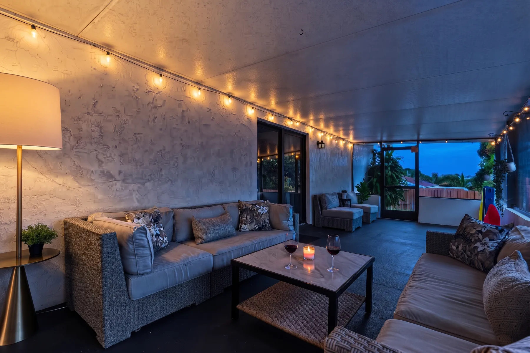 Screened lanai in the evening under string lights
