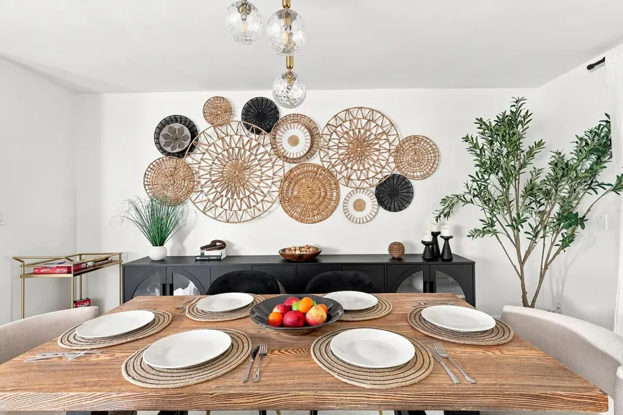 Dining room with a rattan wall treatment and a solid wood table